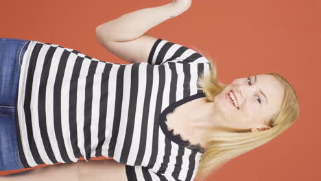 Vertical-video-of-The-woman-promoting-is-pointing-to-the-side-and-laughing.